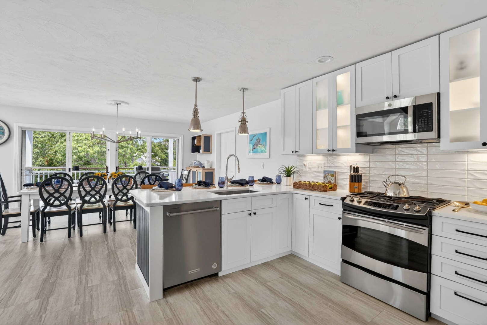 9 Thaxter Lane Edgartown, MA 02539 - Photo 15 of 53 a kitchen with stainless steel appliances a kitchen island hardwood floor sink stove dining table and chairs