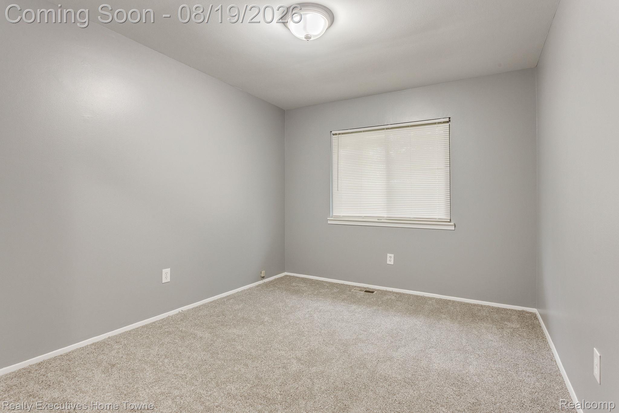 2448 Oakcrest Road Sterling Heights, MI 48310 - Photo 17 of 31 Recessed lighting, light gray painted walls, window with blinds, and neutral carpet flooring
