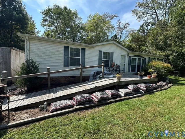 a front view of house with yard and outdoor seating