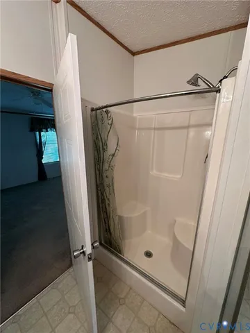 a view of a chair and table in backyard of the house