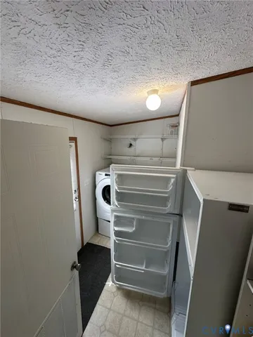 a view of hallway with stainless steel appliances a refrigerator and a window