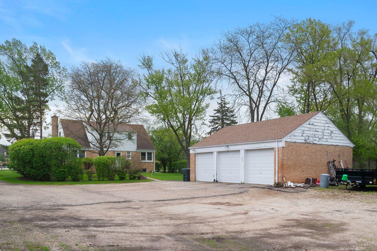 1450 Sanders Road Northbrook, IL 60062 - Photo 4 of 8 a front view of a house with a yard and garage