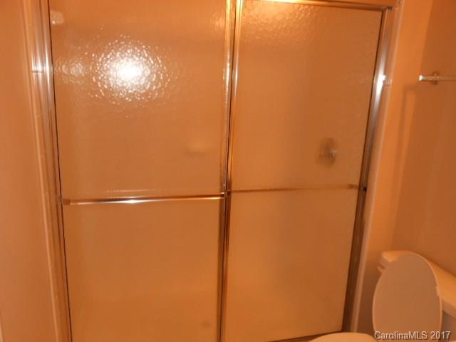16644 Amberside Road East, Unit E Cornelius, NC 28031 - Photo 11 of 16 a bathroom with a glass shower door