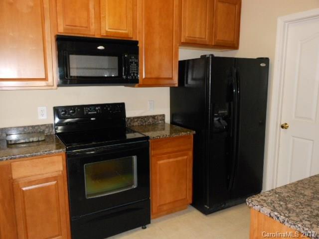 16644 Amberside Road East, Unit E Cornelius, NC 28031 - Photo 4 of 16 a kitchen with stainless steel appliances granite countertop a refrigerator and a stove top oven