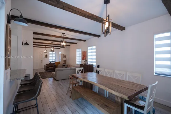 a living room with furniture a ceiling fan and a window