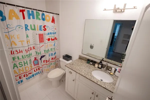 a bathroom with a sink toilet and a mirror