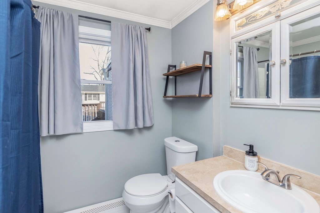 37 Coolidge Road Chicopee, MA 01013 - Photo 23 of 35 a bathroom with a toilet a sink and mirror