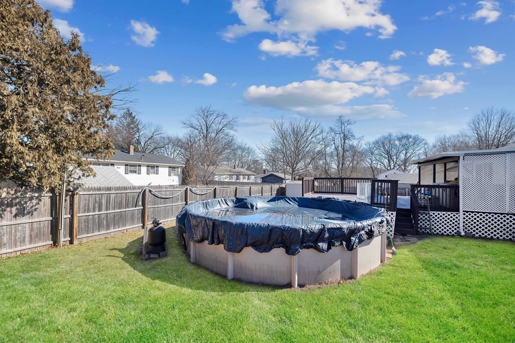 37 Coolidge Road Chicopee, MA 01013 - Photo 31 of 35 a view of a backyard with barbeque grill and a garden