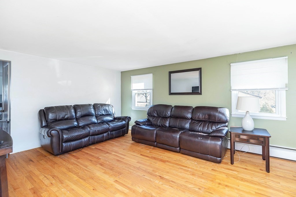 37 Coolidge Road Chicopee, MA 01013 - Photo 5 of 35 a living room with a couch wooden floor and a window