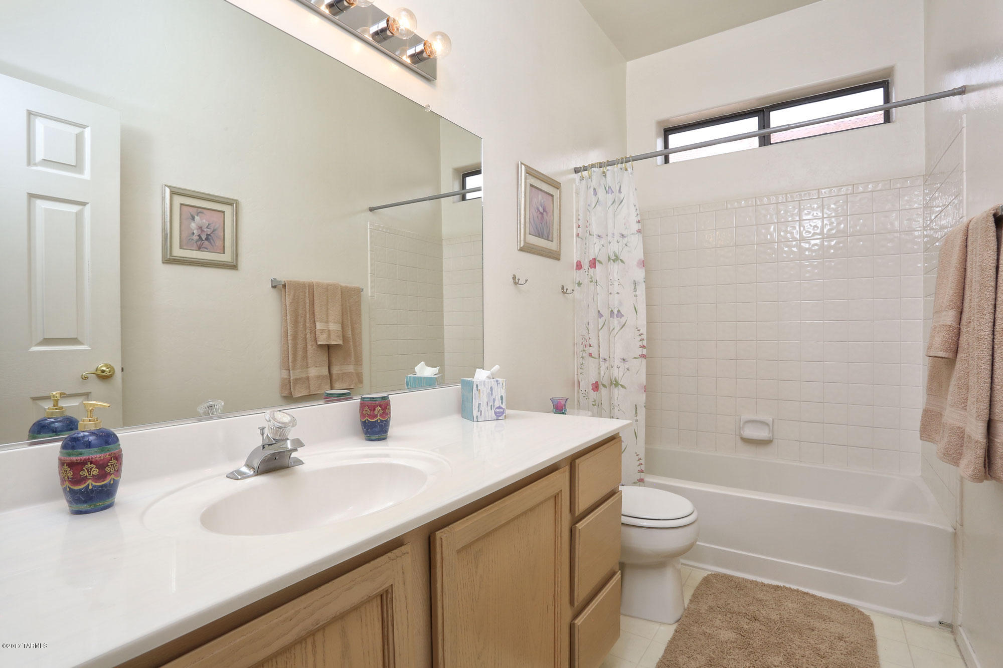 9182 East Dawn Post Road Tucson, AZ 85749 - Photo 19 of 25 a bathroom with a sink a toilet and shower