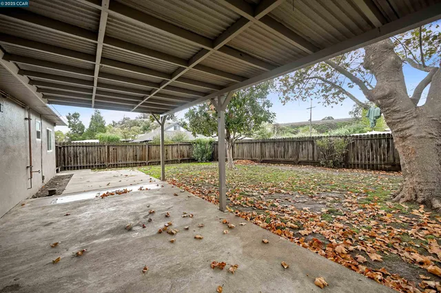 a view of a backyard with wooden fence