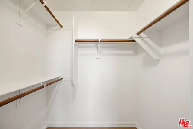 a view of a room with wooden floor and white walls