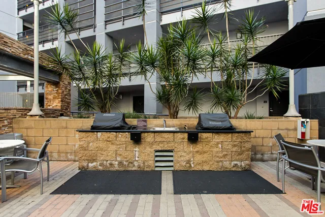 a view of a patio with couches table and chairs and potted plants