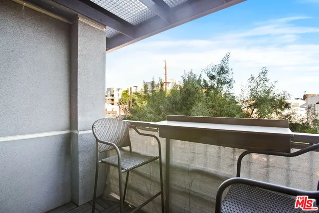 a balcony with table and chairs