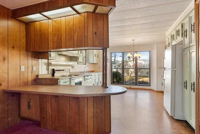 a kitchen with cabinets and window