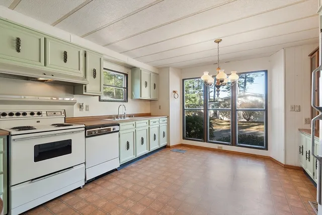 a view of a hallway with chandelier