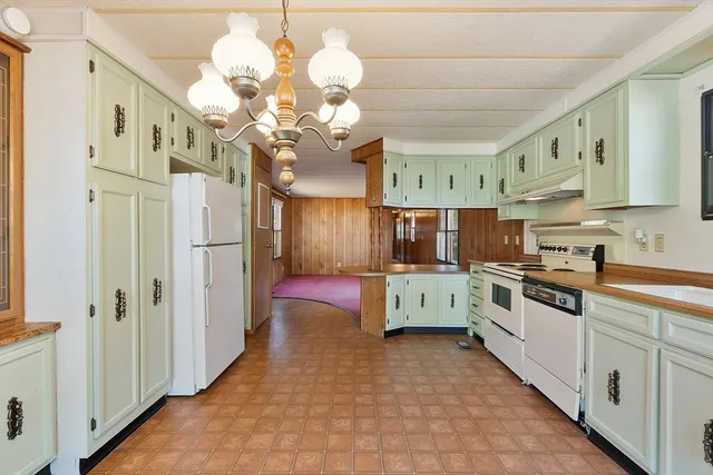 a bathroom with a granite countertop sink a mirror and shower