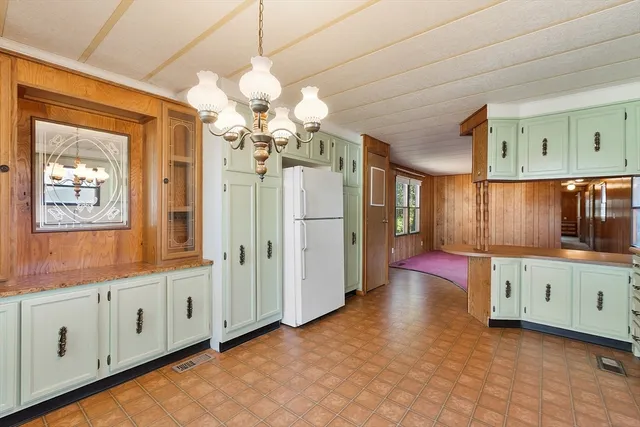 a bathroom with a granite countertop sink mirror and a bathtub
