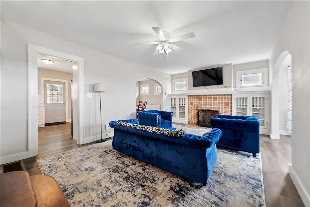 53 Calhoun Avenue Pittsburgh, PA 15210 - Photo 2 of 30 a living room with furniture a fireplace and a flat screen tv