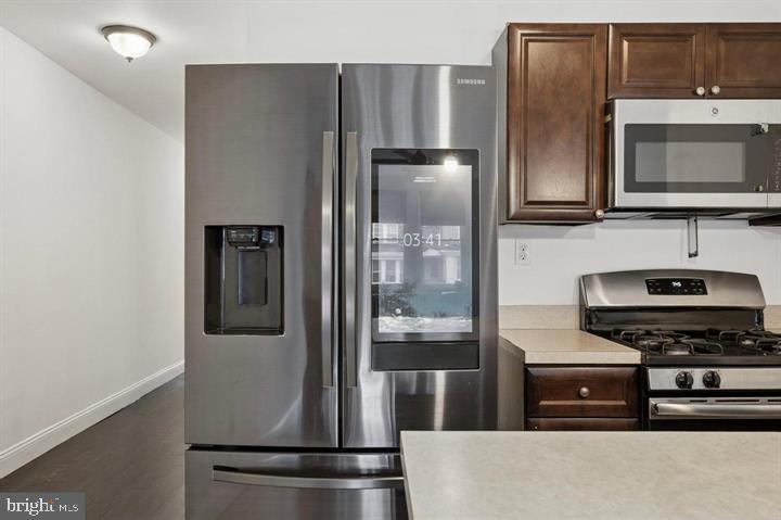 2467 79th Avenue, Unit 1 Philadelphia, PA 19150 - Photo 7 of 16 a kitchen with a refrigerator and a stove
