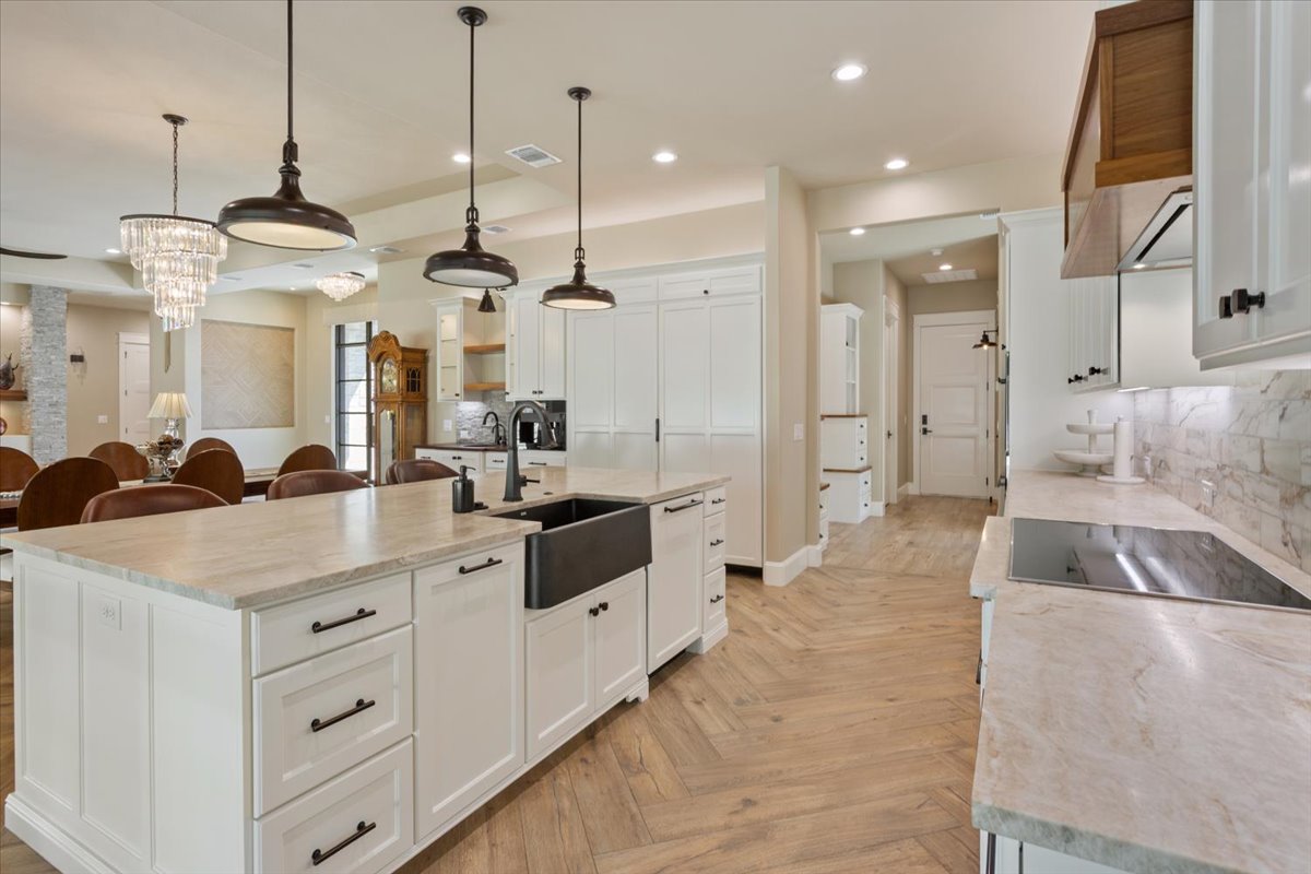 309 Highland Spring Lane Georgetown, TX 78633 - Photo 11 of 40 All Kitchen Countertops are Taj Mahal Quartzite. Designer Stovetop is Miele 36"Induction Cook Top, 5 Cooking Zones. Also a 36" Miele Extra Slim Insert Hood above the stovetop...