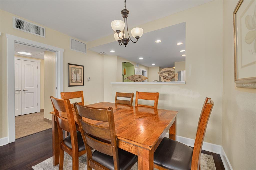 399 2nd Street, Unit 219 Indian Rocks Beach, FL 33785 - Photo 11 of 46 a view of a dining room with furniture and wooden floor