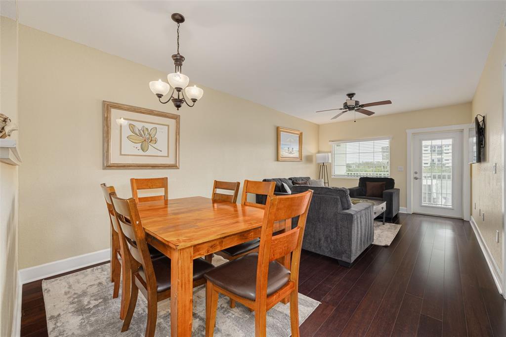 399 2nd Street, Unit 219 Indian Rocks Beach, FL 33785 - Photo 12 of 46 a view of a dining room with furniture wooden floor and chandelier
