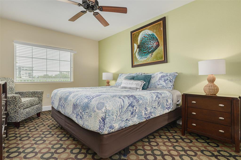 399 2nd Street, Unit 219 Indian Rocks Beach, FL 33785 - Photo 21 of 46 a bedroom with a bed and a painting on the wall