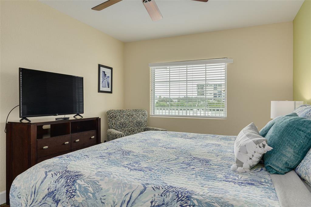 399 2nd Street, Unit 219 Indian Rocks Beach, FL 33785 - Photo 22 of 46 a bedroom with a bed and a flat screen tv
