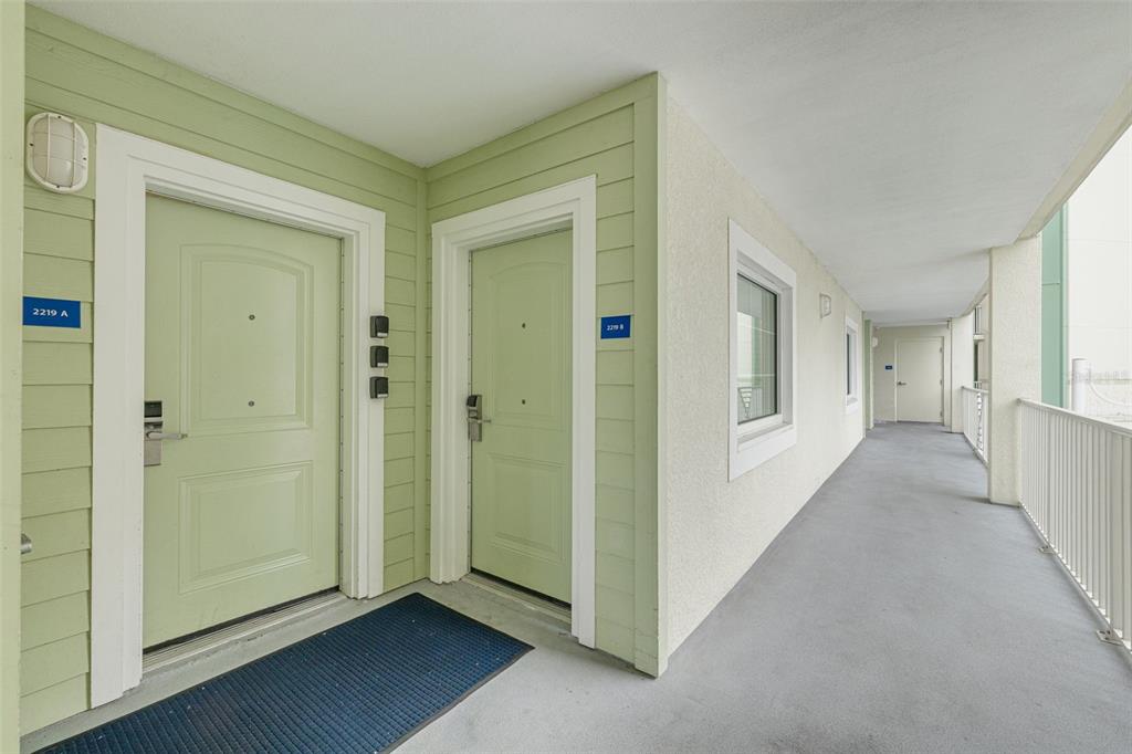 399 2nd Street, Unit 219 Indian Rocks Beach, FL 33785 - Photo 6 of 46 a view of a hallway with wooden floor