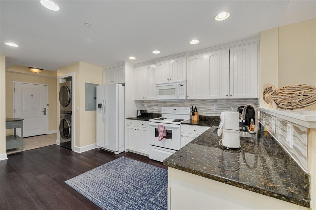 399 2nd Street, Unit 219 Indian Rocks Beach, FL 33785 - Photo 9 of 46 a kitchen with a sink stainless steel appliances and white cabinets