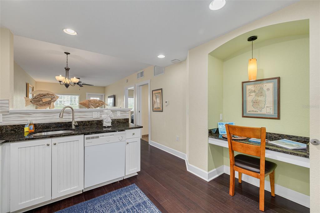 399 2nd Street, Unit 219 Indian Rocks Beach, FL 33785 - Photo 10 of 46 a kitchen with granite countertop a sink cabinets and wooden floor