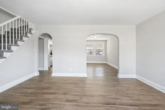 a view of empty room with wooden floor