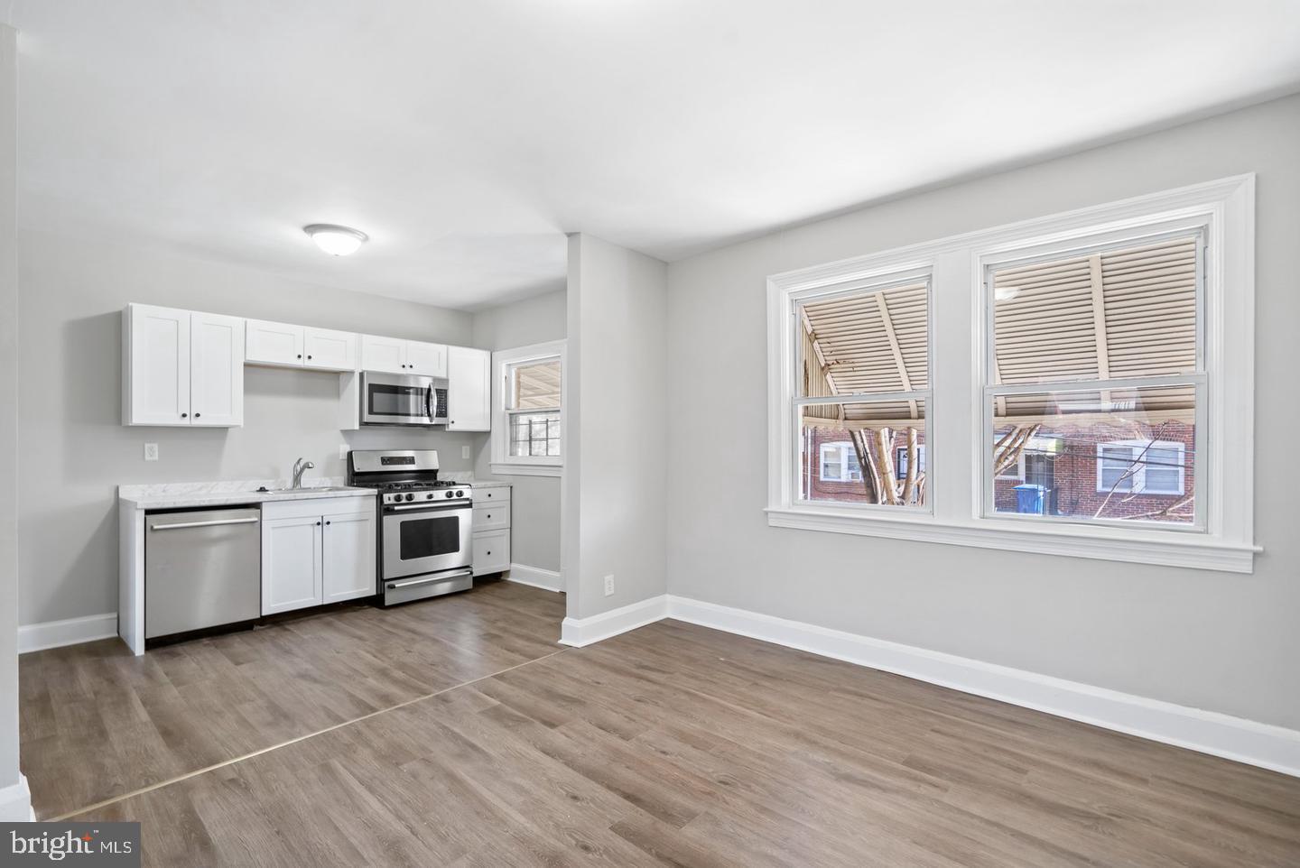 5 North Rosedale Street Baltimore, MD 21229 - Photo 5 of 11 a kitchen with stainless steel appliances a white cabinets and a window