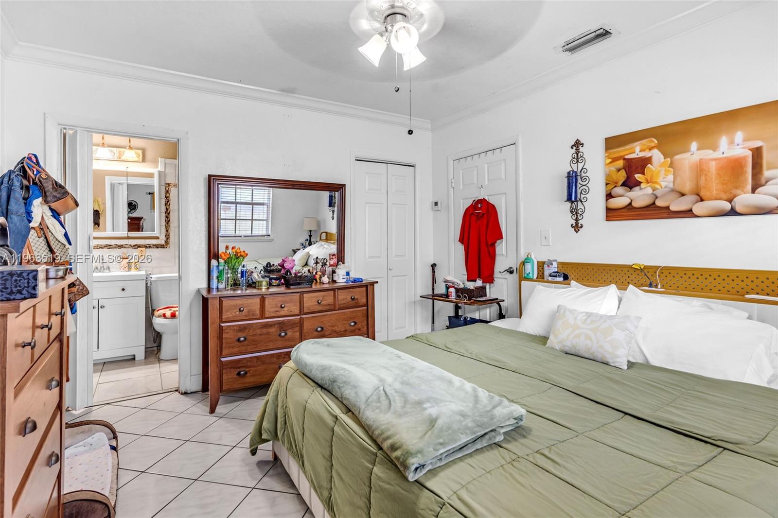 a bedroom with a bed and dresser