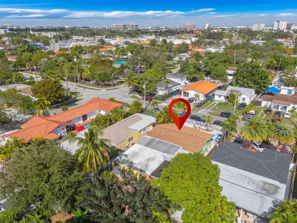 an aerial view of residential houses with outdoor space and swimming pool