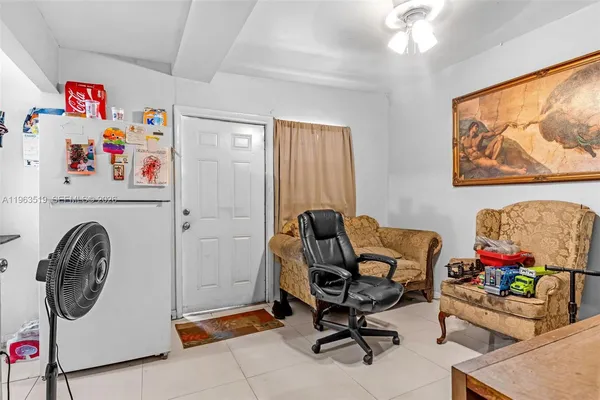 a bedroom with a bed and a table in it with window