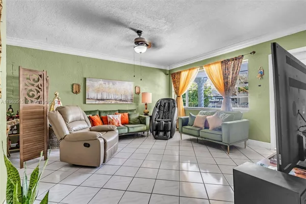 a living room with furniture and large windows