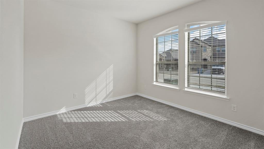 447 Epiphany Lane Lavon, TX 75166 - Photo 20 of 31 Room featuring light gray walls, gray carpeting, and white baseboards