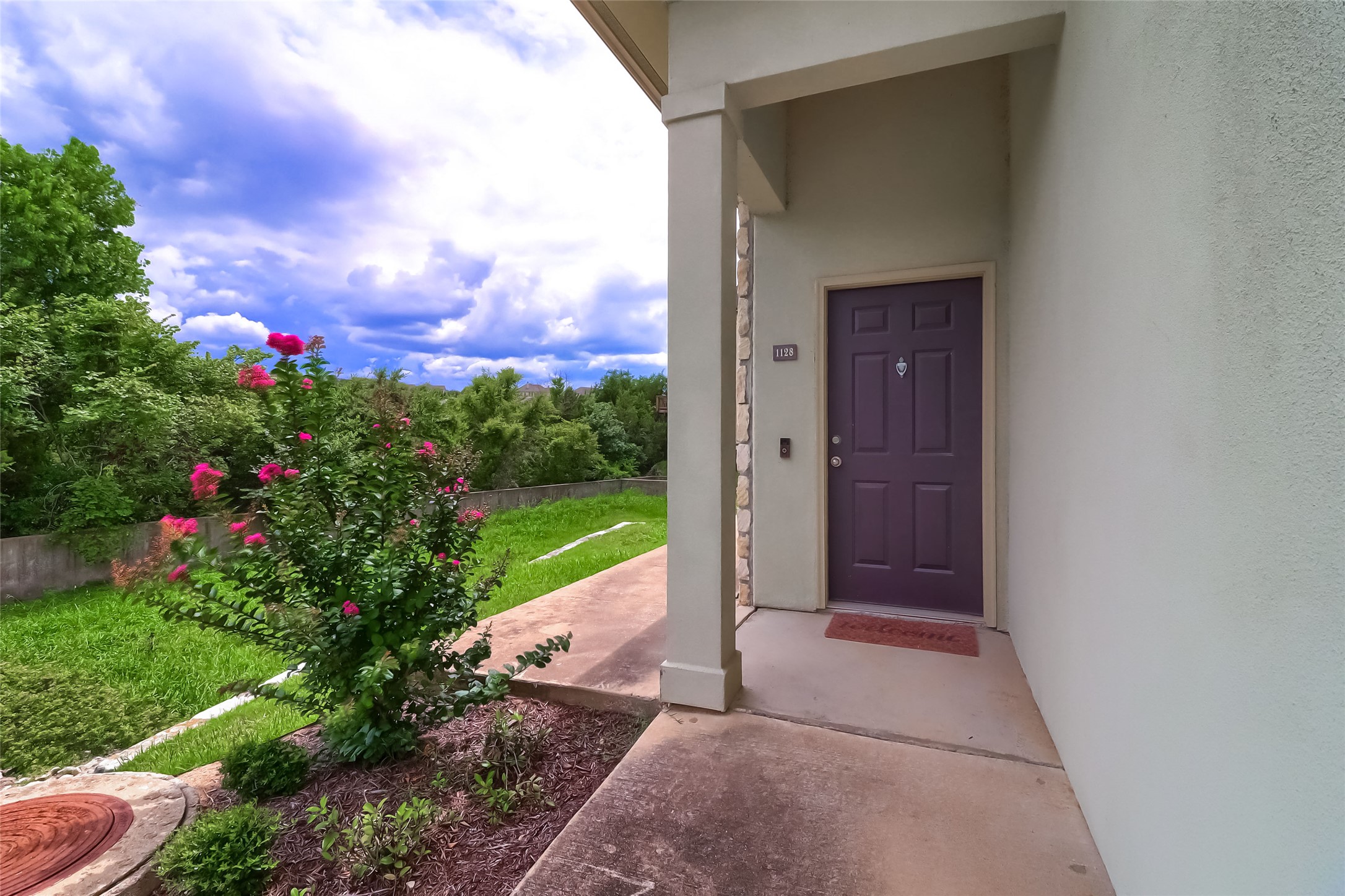 7701 Rialto Boulevard, Unit 1128 Austin, TX 78735 - Photo 28 of 35 a view of yellow house with a yard and garden