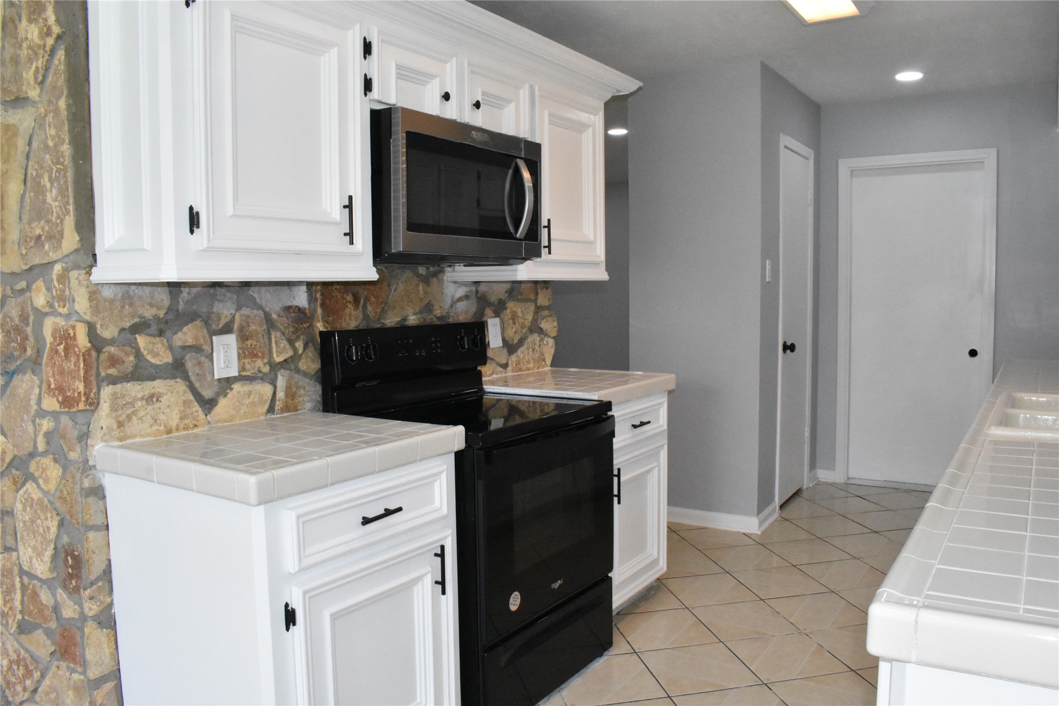 1347 Somercotes Lane Channelview, TX 77530 - Photo 10 of 30 a kitchen with a sink and a stove top oven with wooden floor