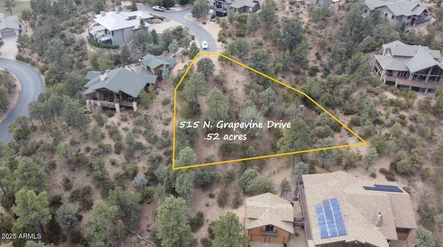 an aerial view of a house with yard and outdoor seating