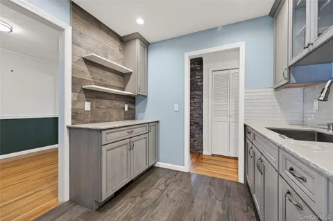 a kitchen with granite countertop a sink and a stove top oven