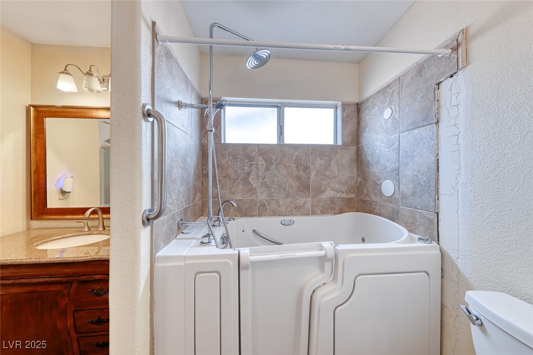 632 Arrayo Way Boulder City, NV 89005 - Photo 26 of 40 Full bath featuring vanity, toilet, and a textured wall
