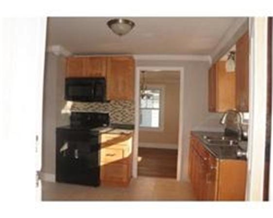 96 Appleton Street Springfield, MA 01108 - Photo 2 of 9 a living room with furniture and a flat screen tv
