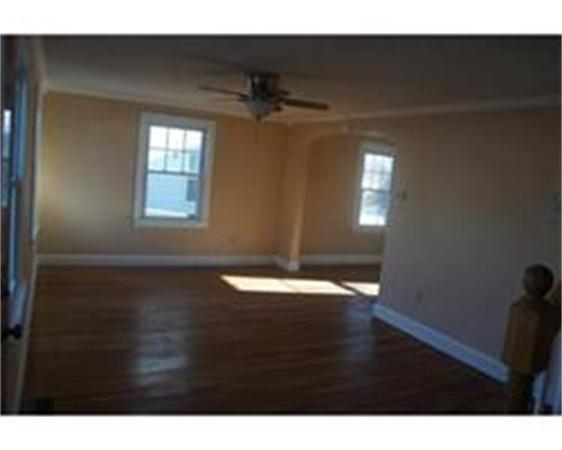 96 Appleton Street Springfield, MA 01108 - Photo 3 of 9 a view of empty room with wooden floor and fan