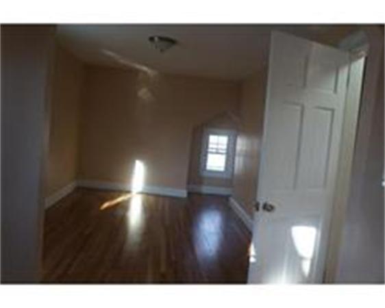 96 Appleton Street Springfield, MA 01108 - Photo 5 of 9 a view of an empty room with wooden floor and a window