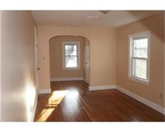 96 Appleton Street Springfield, MA 01108 - Photo 6 of 9 a view of empty room with wooden floor and fan