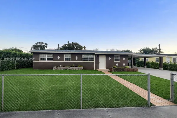 a front view of a house with a yard table and chairs