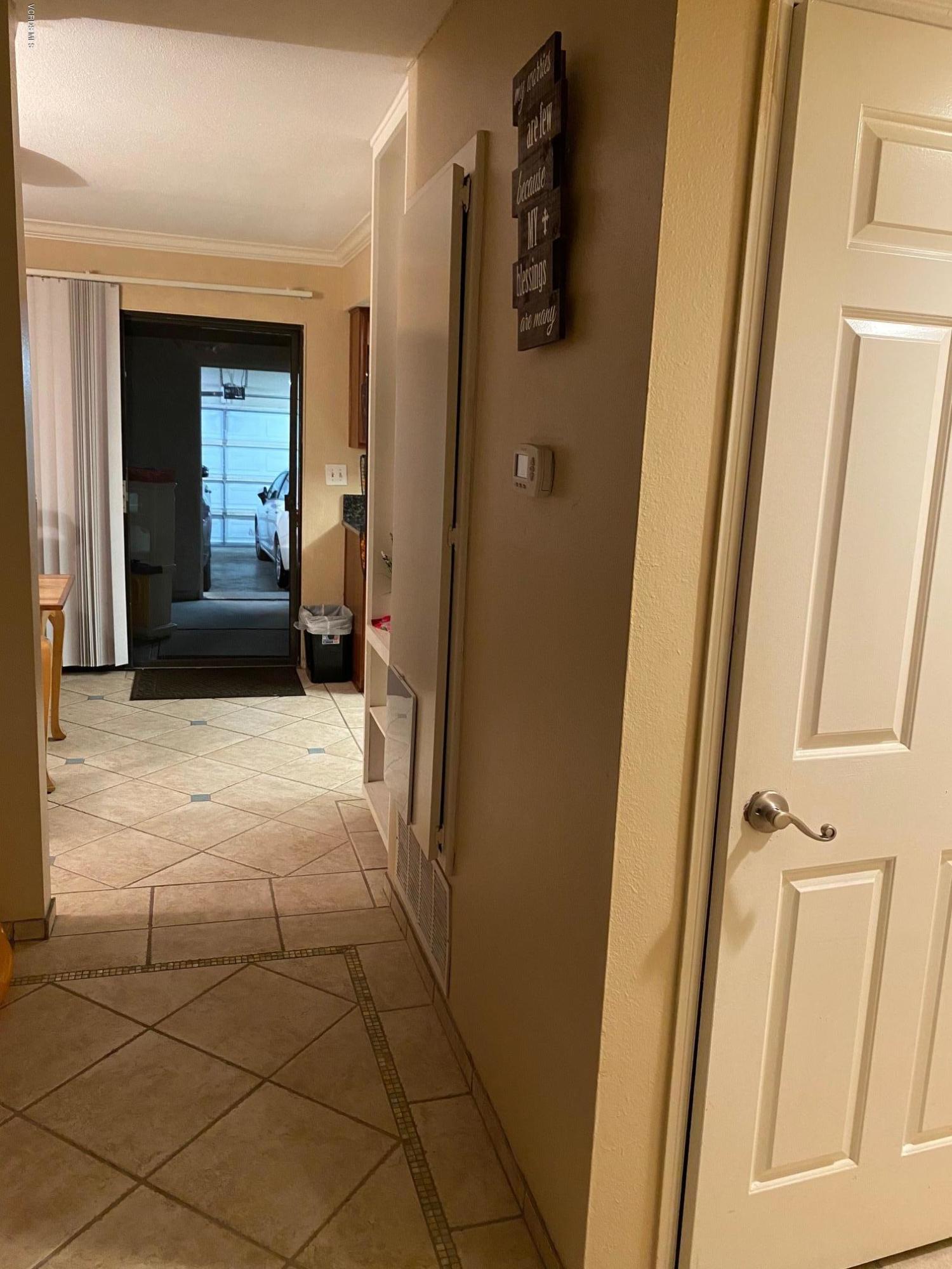 2011 East Bard Road Oxnard, CA 93033 - Photo 8 of 9 a view of a hallway with wooden floor and a bathroom